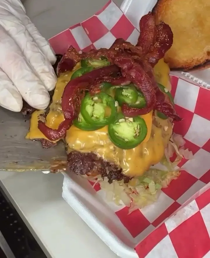 Bacon jalapeno smash burger with candied bacon, jalapenos and sauce