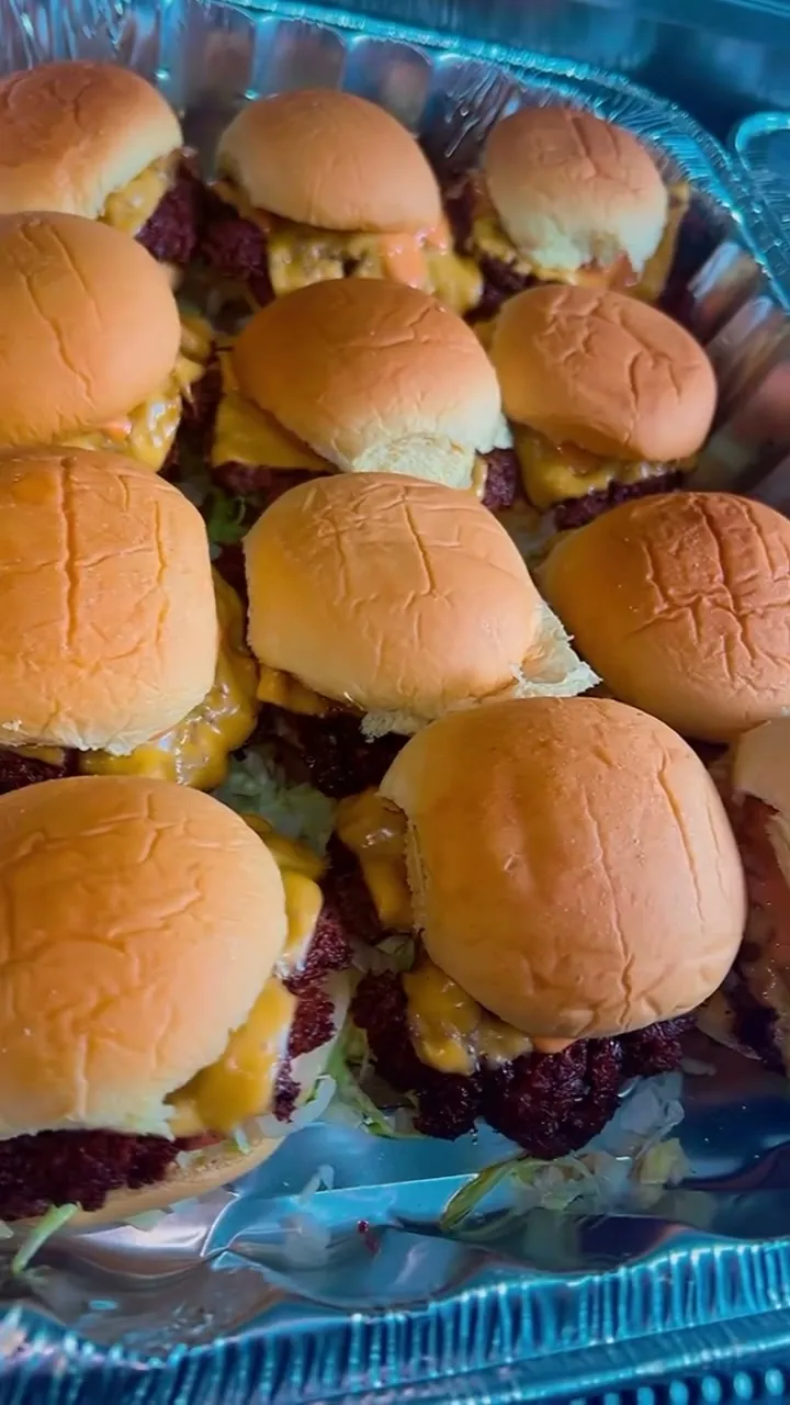 Catering trays packed with sliders for an event