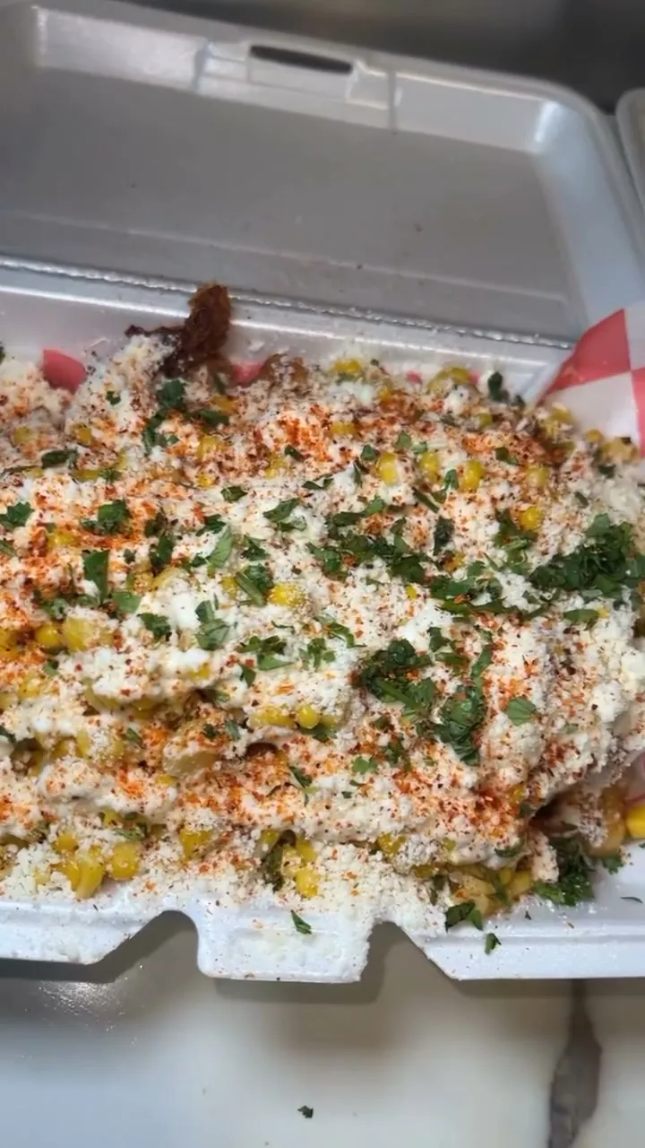 Elote fries loaded with roasted corn, crema, cotija, cilantro and Tajin
