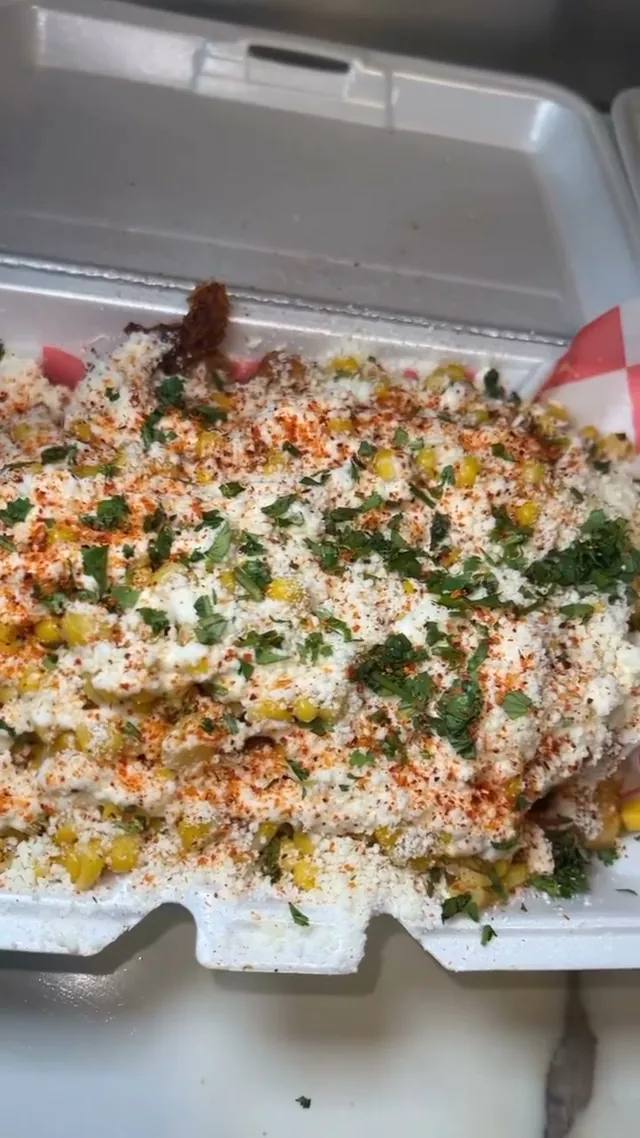 Elote fries loaded with roasted corn, crema, cotija, cilantro and Tajin
