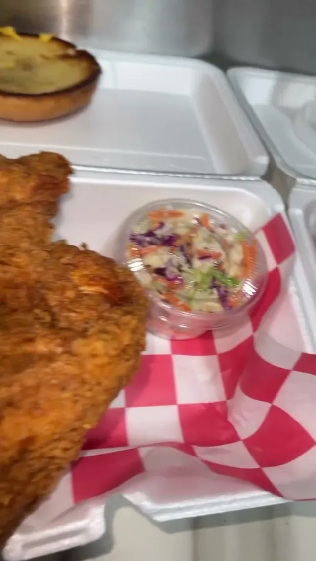 Golden fried chicken breast on red checkered paper