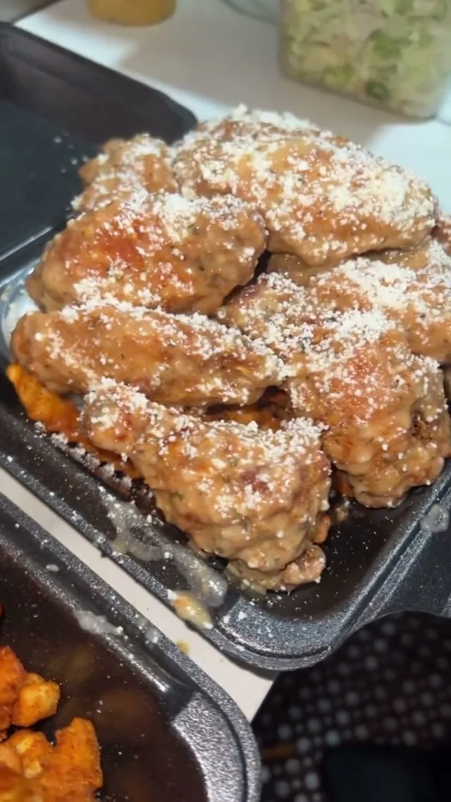 Garlic parmesan wings dusted with grated cheese