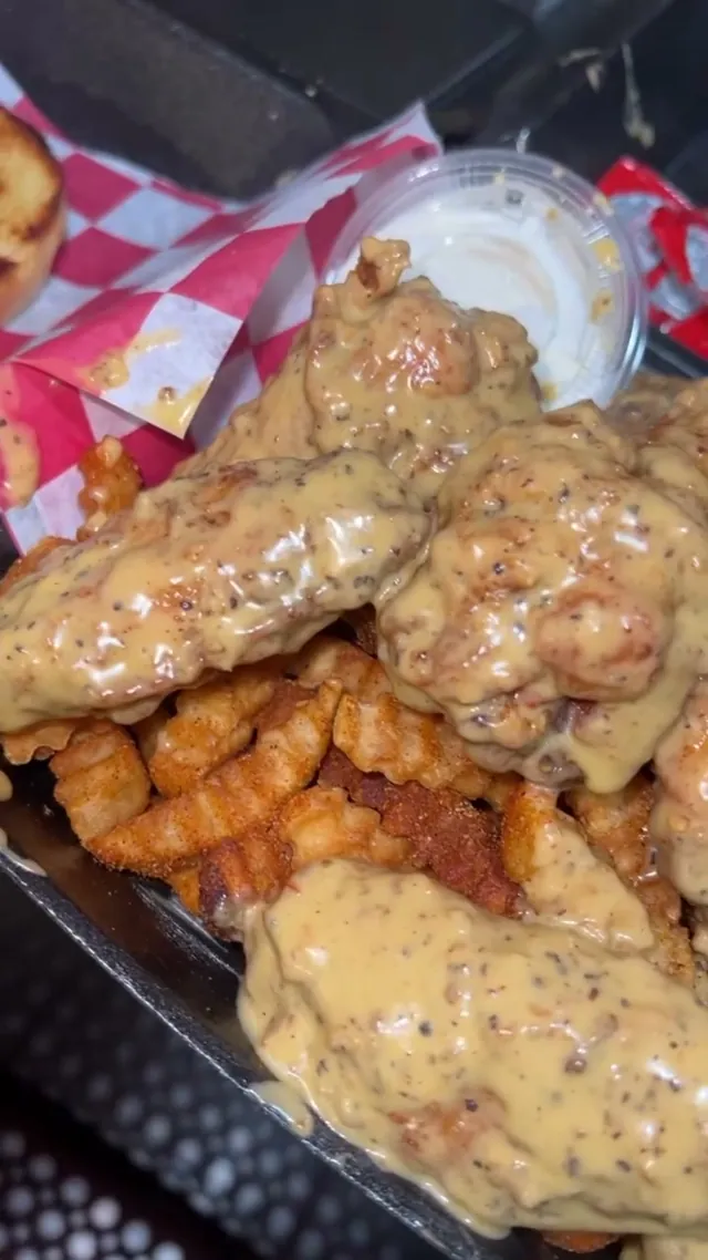 Chicken tenders smothered in house comeback sauce over fries