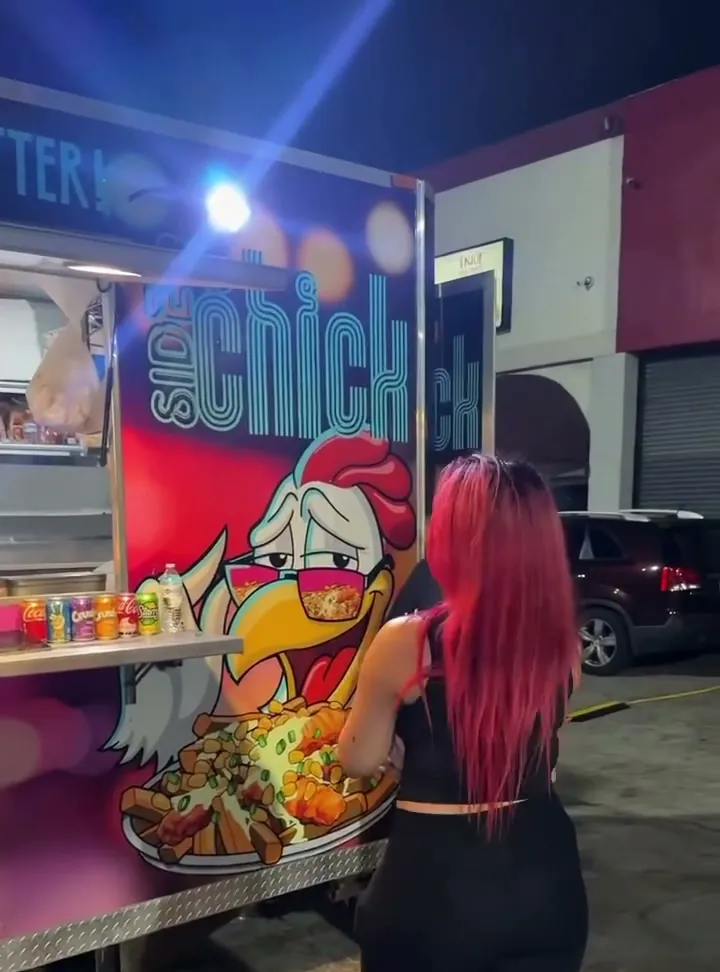 The Side Chick food truck lit up at night in West Kendall, Miami
